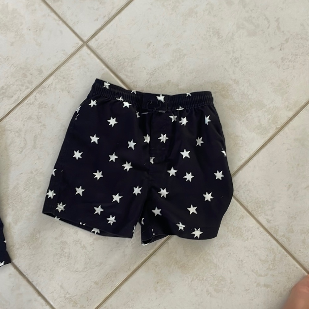 Black swim trunks with white stars on it